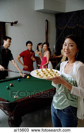 Woman with plate of appetizers, smiling at camera, people in the background View Large Photo Image Stock Image - Woman with plate of appetizers, smiling at camera, people in the background. Fotosearch