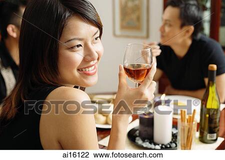 Woman with wine glass, looking away, smiling View Large Photo Image Stock Image - Woman with wine glass, looking away, smiling. Fotosearch