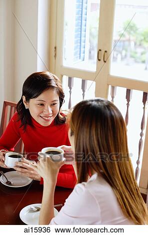 Women having coffee in cafe View Large Photo Image Stock Photograph - Women having coffee in cafe. Fotosearch