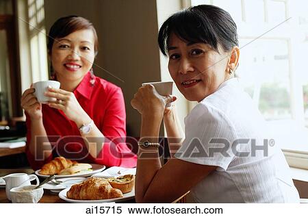 Women having tea at cafe, looking at camera View Large Photo Image Stock Photography - Women having tea at cafe, looking at camera. Fotosearch