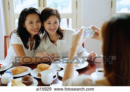 Women in cafe, posing for photograph View Large Photo Image Stock Photo - Women in cafe, posing for photograph. Fotosearch