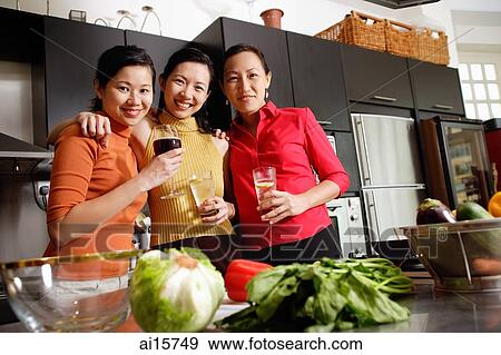 Women in kitchen, standing side by side, smiling at camera View Large Photo Image Stock Photo - Women in kitchen, standing side by side, smiling at camera. Fotosearch