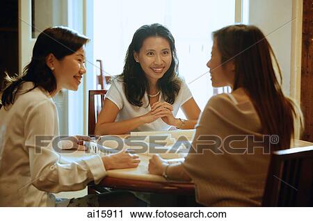 Stock Image - Women playing mahjong. Fotosearch