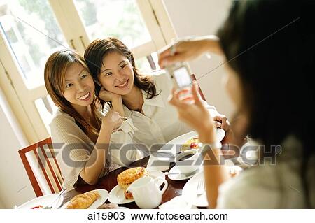 Women posing for photograph, smiling View Large Photo Image Stock Image - Women posing for photograph, smiling. Fotosearch