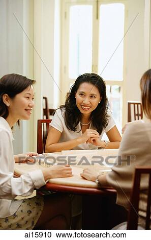 Women sitting around mahjong table, talking View Large Photo Image Stock Image - Women sitting around mahjong table, talking. Fotosearch