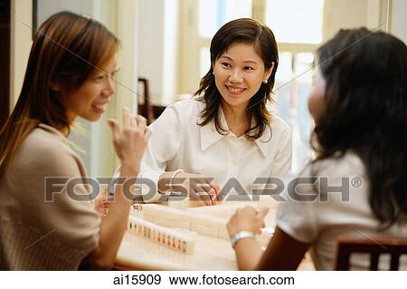 Women sitting around mahjong table View Large Photo Image Stock Photo - Women sitting around mahjong table. Fotosearch