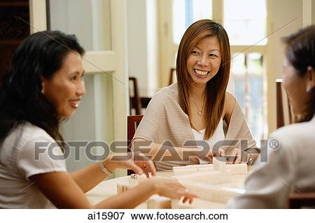 Women sitting around table, playing mahjong View Large Photo Image Stock Photo - Women sitting around table, playing mahjong. Fotosearch