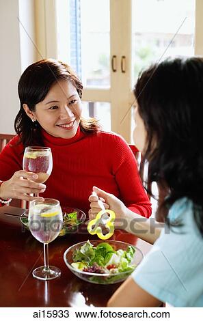 Women sitting at a cafe having lunch View Large Photo Image Stock Image - Women sitting at a cafe having lunch. Fotosearch