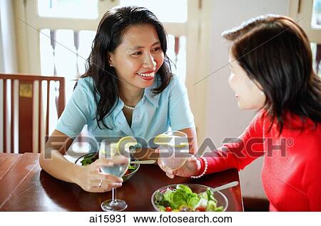 Women sitting at a cafe, having salad lunch View Large Photo Image Stock Image - Women sitting at a cafe, having salad lunch. Fotosearch