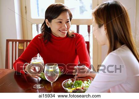 Picture - Women sitting, having lunch at cafe. Fotosearch