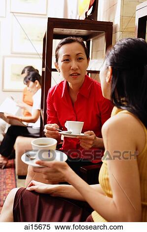 Women sitting, talking, holding cups and saucers View Large Photo Image Stock Photography - Women sitting, talking, holding cups and saucers. Fotosearch
