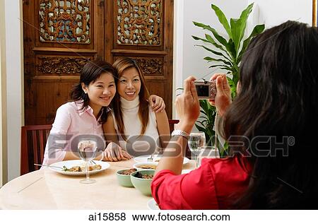 Women taking picture of friends View Large Photo Image Stock Photo - Women taking picture of friends. Fotosearch
