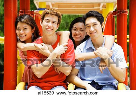 Young adults in playground, looking at camera View Large Photo Image Stock Photo - Young adults in playground, looking at camera. Fotosearch