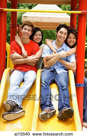 Young adults in playground, smiling at camera, portrait View Large Photo Image Stock Image - Young adults in playground, smiling at camera, portrait. Fotosearch