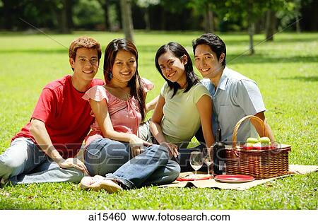 Young adults sitting in park, looking at camera, portrait View Large Photo Image Stock Image - Young adults sitting in park, looking at camera, portrait. Fotosearch