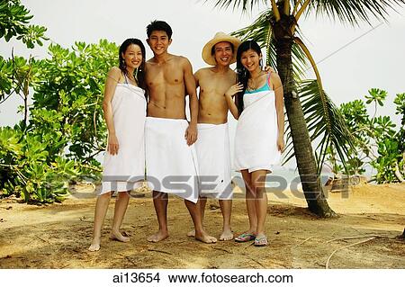 Young adults wearing towels, standing in a row, looking at camera View Large Photo Image Picture - Young adults wearing towels, standing in a row, looking at camera. Fotosearch