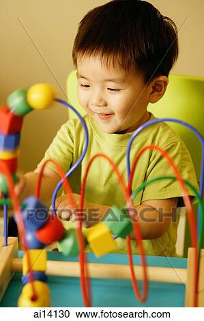 Young boy playing with toy View Large Photo Image Stock Image - Young boy playing with toy. Fotosearch