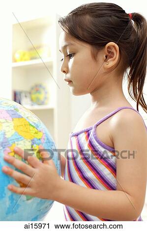 Stock Image - Young girl holding globe. Fotosearch