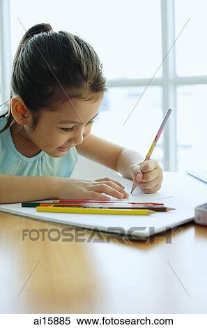 Stock Photography - Young girl holding pencil, drawing. Fotosearch