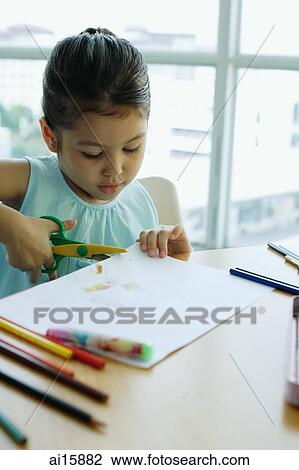 Young girl holding scissors, cutting paper View Large Photo Image Stock Image - Young girl holding scissors, cutting paper. Fotosearch