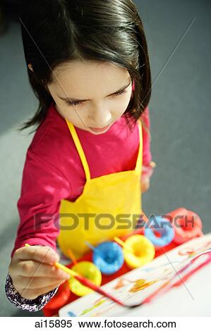 Stock Photography - Young girl painting, high angle view. Fotosearch