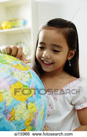 Young girl pointing at a globe View Large Photo Image Stock Photograph - Young girl pointing at a globe. Fotosearch
