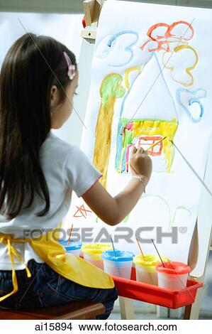 Young girl sitting in front of easel, painting View Large Photo Image Picture - Young girl sitting in front of easel, painting. Fotosearch