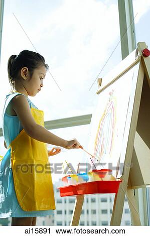 Young girl standing in front of easel, painting View Large Photo Image Stock Image - Young girl standing in front of easel, painting. Fotosearch