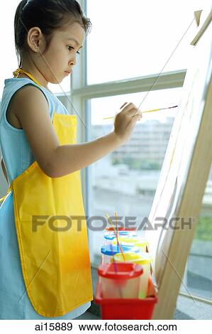 Young girl with apron, painting on easel View Large Photo Image Stock Photo - Young girl with apron, painting on easel. Fotosearch
