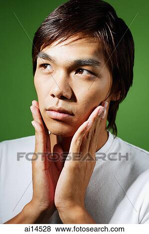 Young man applying aftershave View Large Photo Image Stock Photo - Young man applying aftershave. Fotosearch
