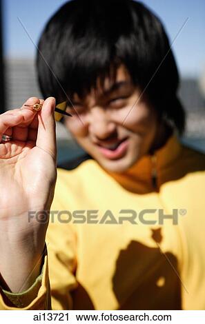 Young man holding dart View Large Photo Image Stock Image - Young man holding dart. Fotosearch