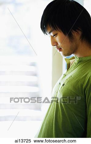 Young man looking down, sideview View Large Photo Image Stock Photography - Young man looking down, sideview. Fotosearch
