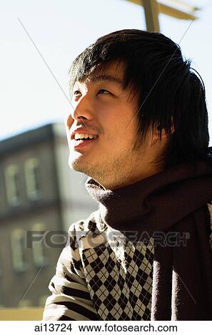 Picture - Young man looking up. Fotosearch