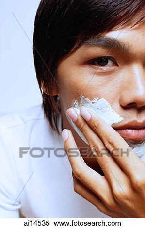 Young man with shaving foam on face View Large Photo Image Stock Photography - Young man with shaving foam on face. Fotosearch