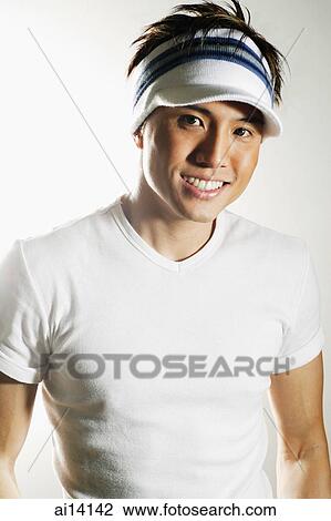Young man with sun visor, looking at camera, smiling View Large Photo Image Stock Image - Young man with sun visor, looking at camera, smiling. Fotosearch