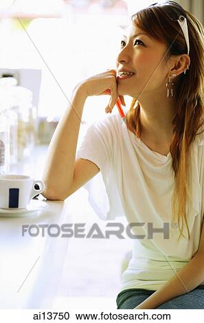 Young woman, hand on chin, looking up View Large Photo Image Stock Image - Young woman, hand on chin, looking up. Fotosearch