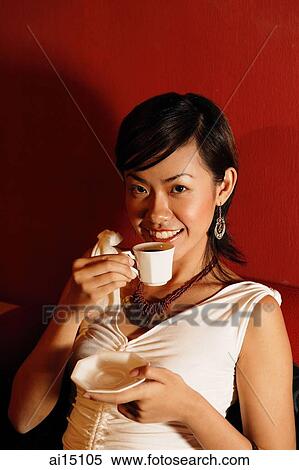 Young woman holding cup and saucer, looking at camera View Large Photo Image Stock Photography - Young woman holding cup and saucer, looking at camera. Fotosearch
