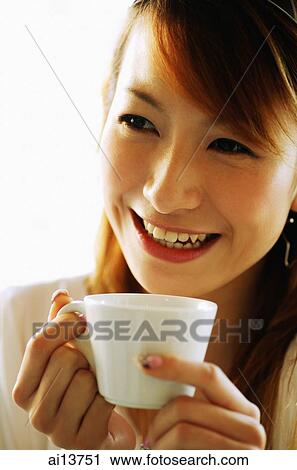 Young woman, holding cup View Large Photo Image Stock Image - Young woman, holding cup. Fotosearch