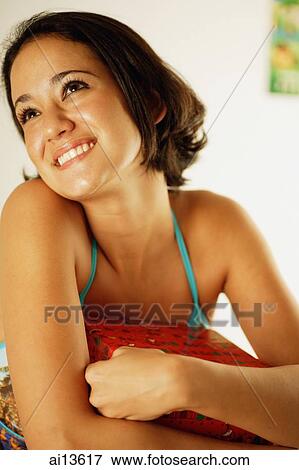Young woman holding wrapped box, looking away View Large Photo Image Stock Photo - Young woman holding wrapped box, looking away. Fotosearch