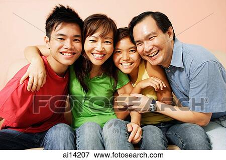 Stock Photo - Young woman in go-cart, father crouching down next to her. Fotosearch