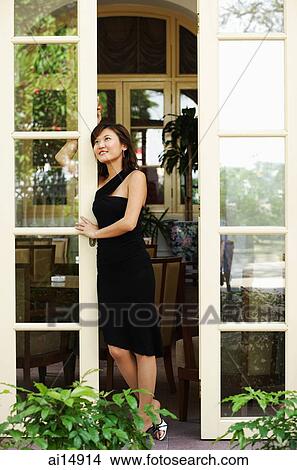 Young woman leaning on door, looking out View Large Photo Image Picture - Young woman leaning on door, looking out. Fotosearch