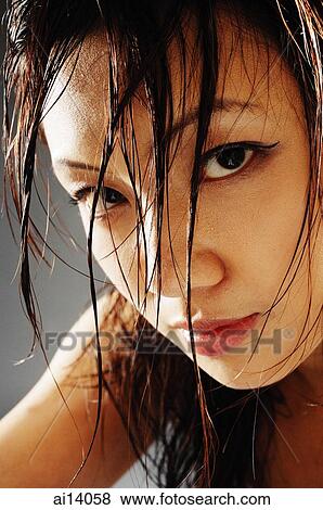 Young woman looking at camera, hair wet View Large Photo Image Stock Photo - Young woman looking at camera, hair wet. Fotosearch