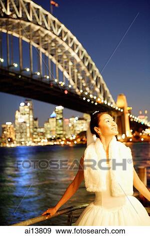Young woman, looking away, bridge and river in the background View Large Photo Image Stock Photo - Young woman, looking away, bridge and river in the background. Fotosearch