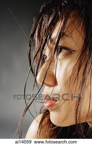 Young woman looking away, hair wet View Large Photo Image Stock Photo - Young woman looking away, hair wet. Fotosearch