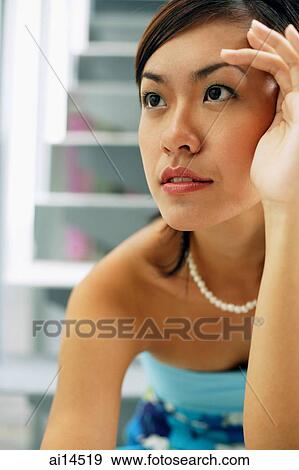 Young woman, looking away, hands on face View Large Photo Image Stock Photo - Young woman, looking away, hands on face. Fotosearch