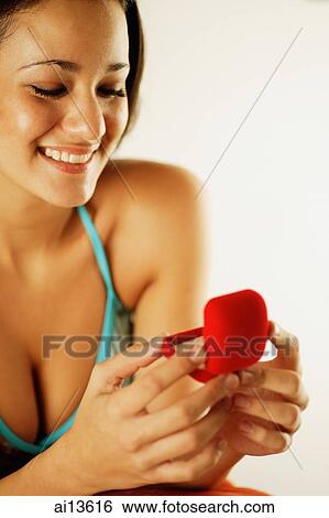 Young woman opening ring box, smiling View Large Photo Image Stock Photograph - Young woman opening ring box, smiling. Fotosearch