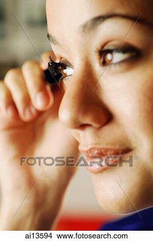 Young woman putting on mascara View Large Photo Image Picture - Young woman putting on mascara. Fotosearch