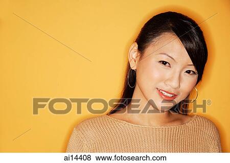 Stock Photo - Young woman smiling at camera, portrait. Fotosearch