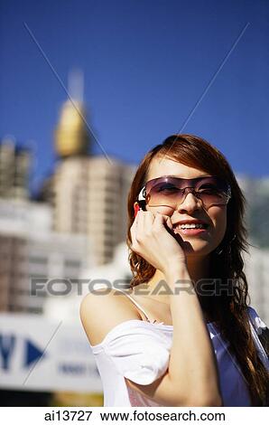 Young woman using mobile phone View Large Photo Image Stock Photo - Young woman using mobile phone. Fotosearch