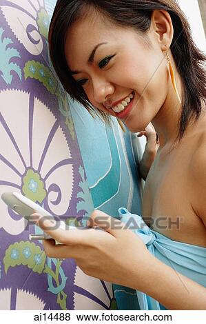 Young woman using mobile phone View Large Photo Image Stock Photo - Young woman using mobile phone. Fotosearch